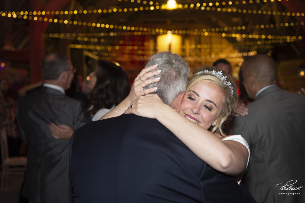 bride and her dad dance fairy lights twinkle other guests