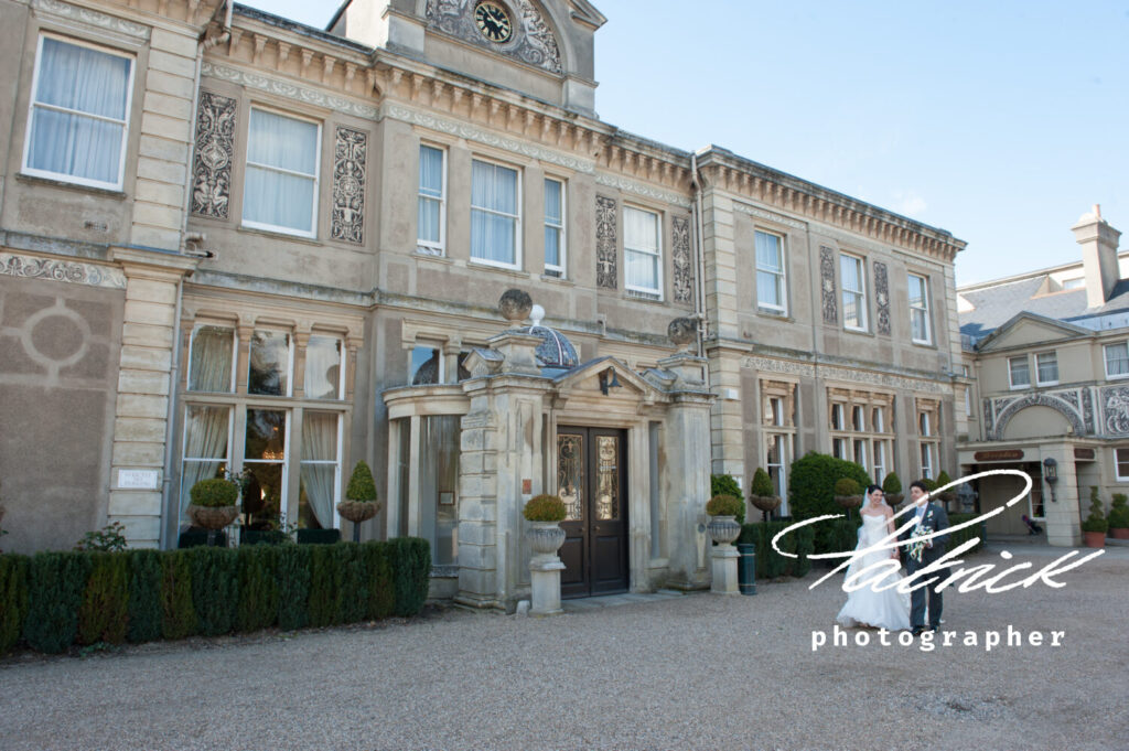 down hall front day time bride and groom walking