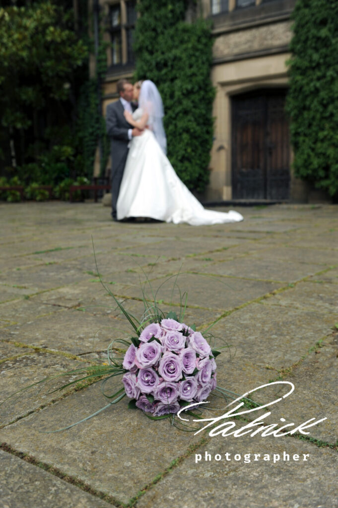outside fanhams, bride and groom, flowers in foreground
