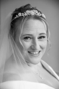 kathryn, bride, head over right shoulder, black and white, headdress, white dress, veil, smiling