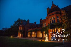 exterior night shot, holmewood hall, bride, groom, kiss, door