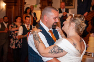 bride kat, groom marc, dance, guests, background