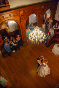 holmewood-hall venue, chandeliers, wooden stairs, aerial view, bride, groom, kat, marc, dance, guests watching