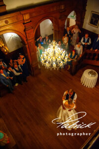 holmewood-hall venue, chandeliers, wooden stairs, aerial view, bride, groom, kat, marc, dance, guests watching