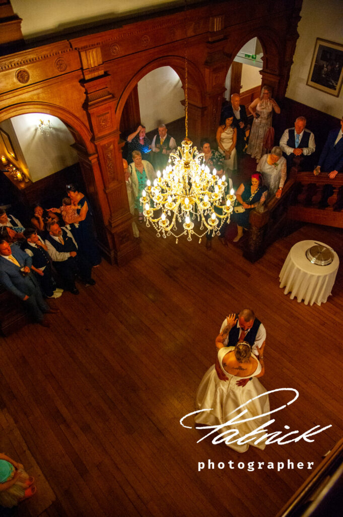 holmewood-hall venue, chandeliers, wooden stairs, aerial view, bride, groom, kat, marc, dance, guests watching