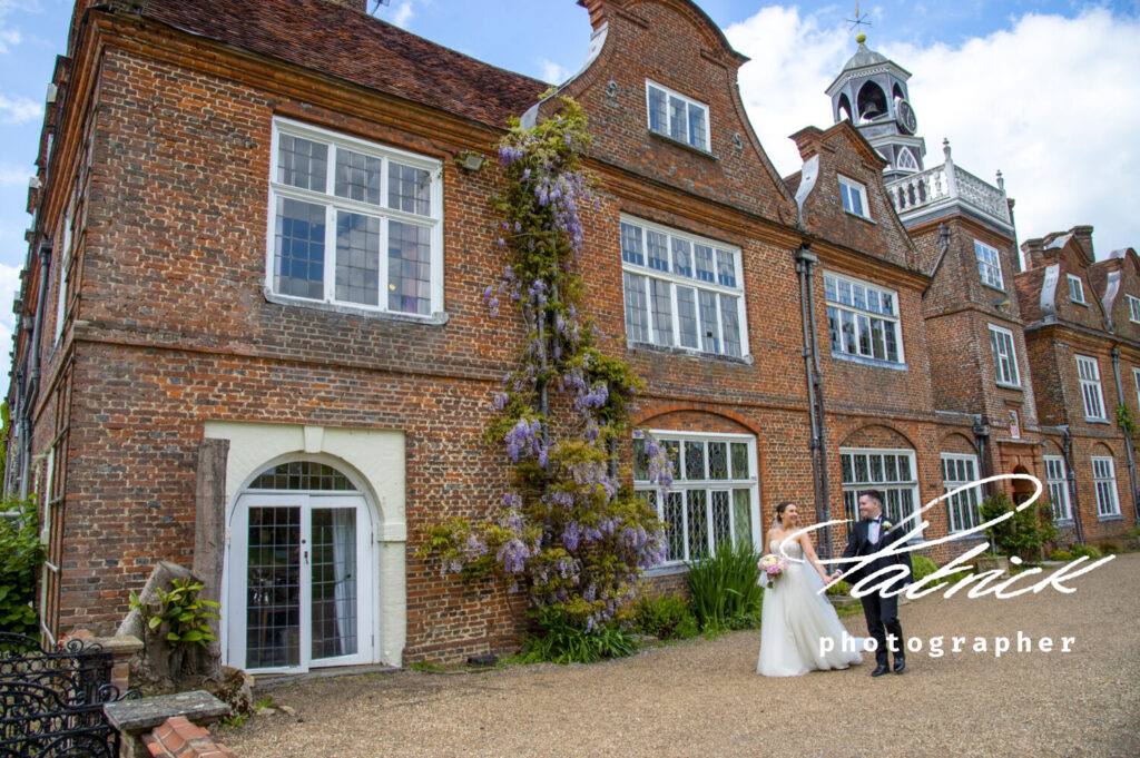 bride and groom, exterior shot, rothamstead manor, gravel, bride holds hands with groom,