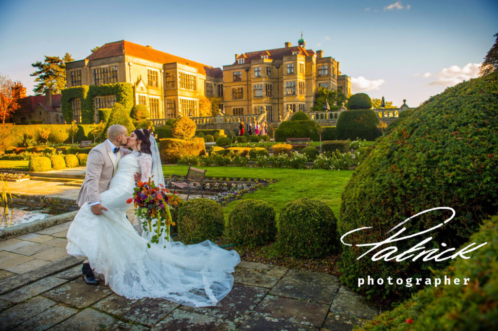 Bride and groom grounds of fanhams hall. day, romantic, fanhams hall in the background, beautiful warm sunny day, winter wedding, autumnal wedding