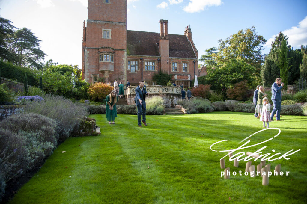 lanwades hall background, manicured lawn, croquet, groom, guests milling