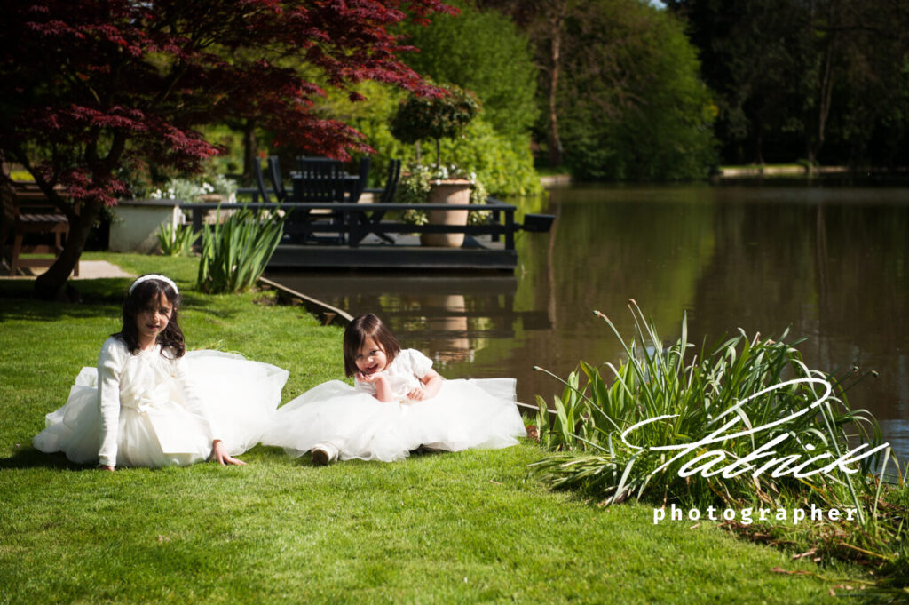 young bridesmaids casually sat by the lake st Michaels manor