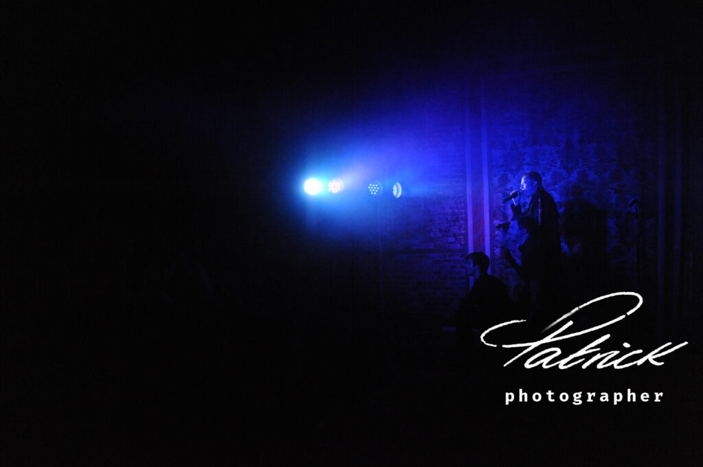tribute Take That Band. Blue spotlight on singer.